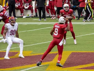 James Conner wearing jersey number 6 during a game, showcasing his skills and determination on the field as a key player for the Arizona Cardinals.